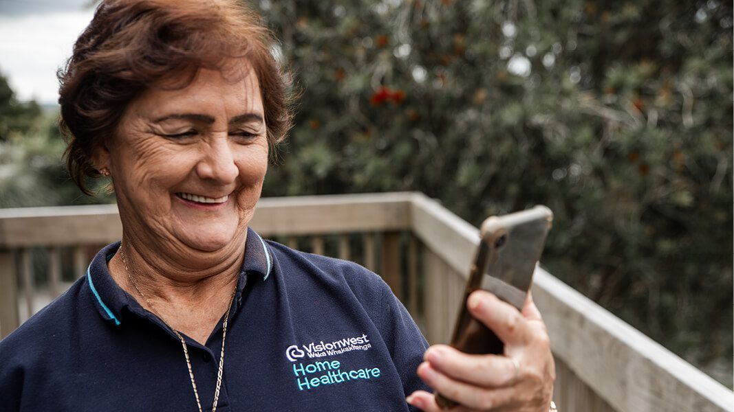 Home healthcare worker looking at phone