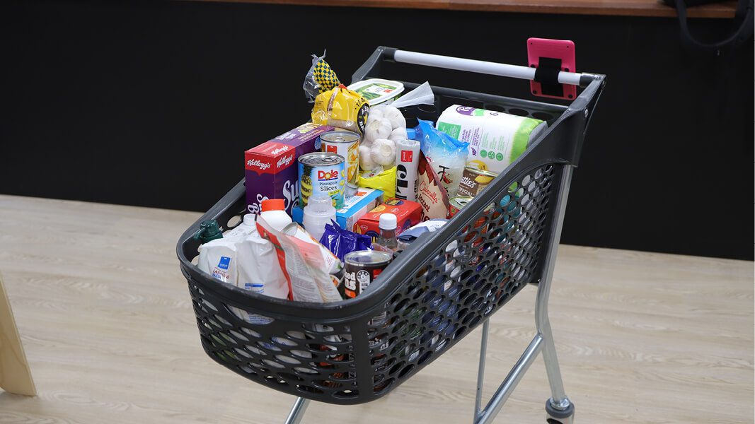 Supermarket cart full of groceries
