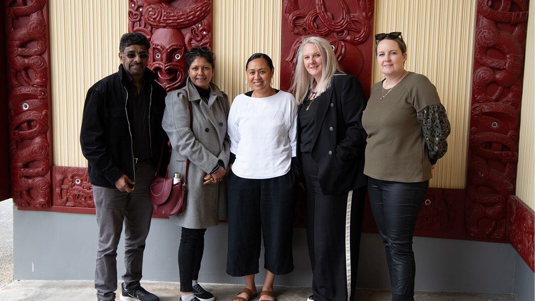 Group of people standing outside Marae