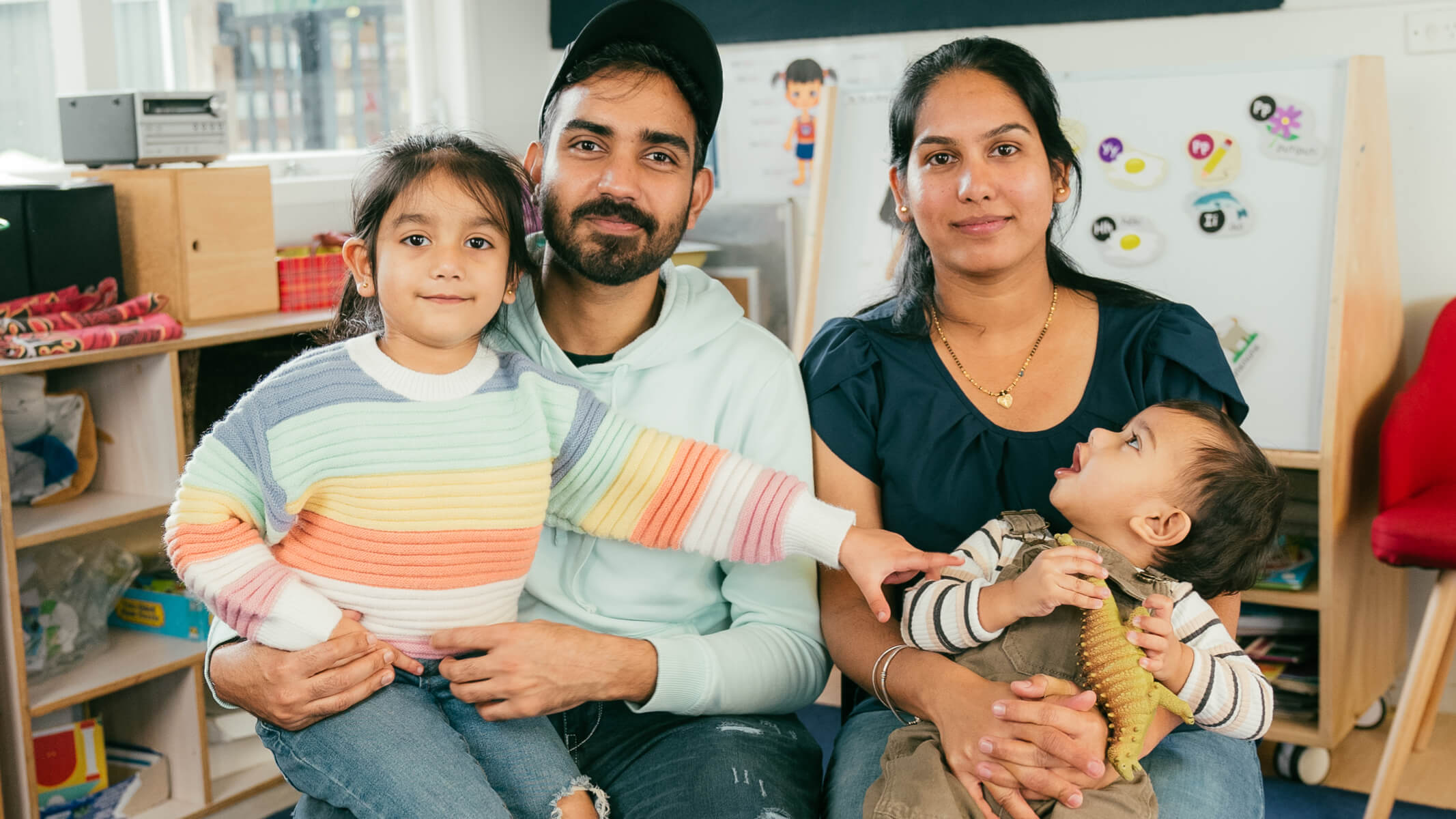 Family sitting on chairs in early childhood centre