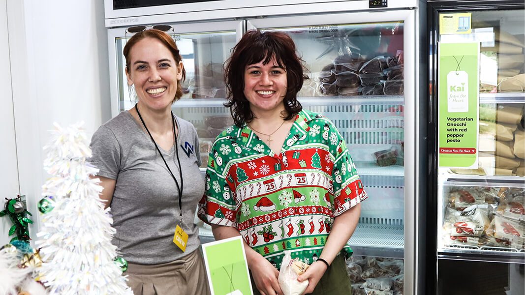 Two people standing in supermarket